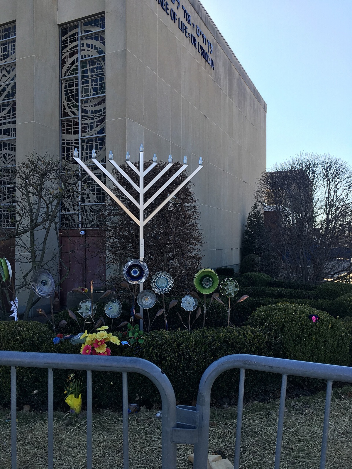 Menorah, flowers, and handmade tributes outside the Tree of Life synagogue in Pittsburgh in March 2019